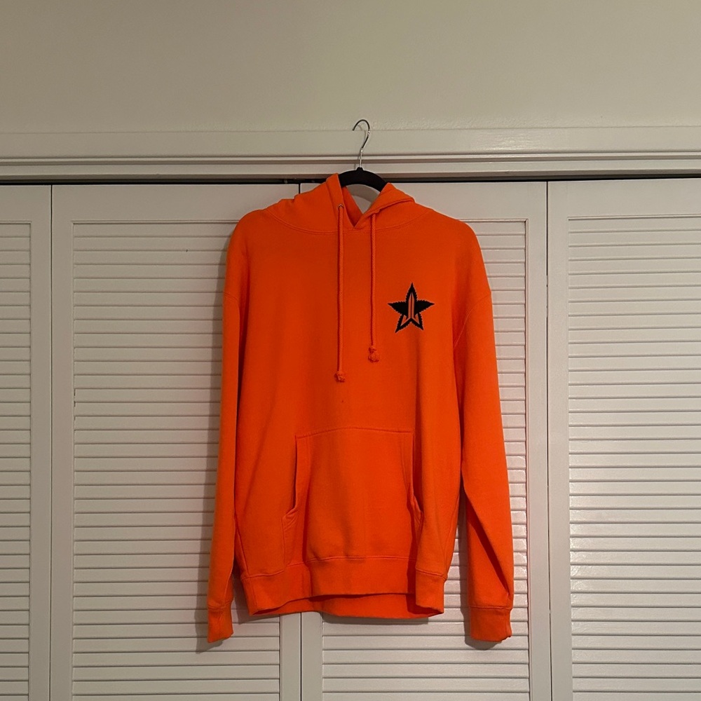 Jeffree Star Vibrant Orange Hoodie with Black Star Logo